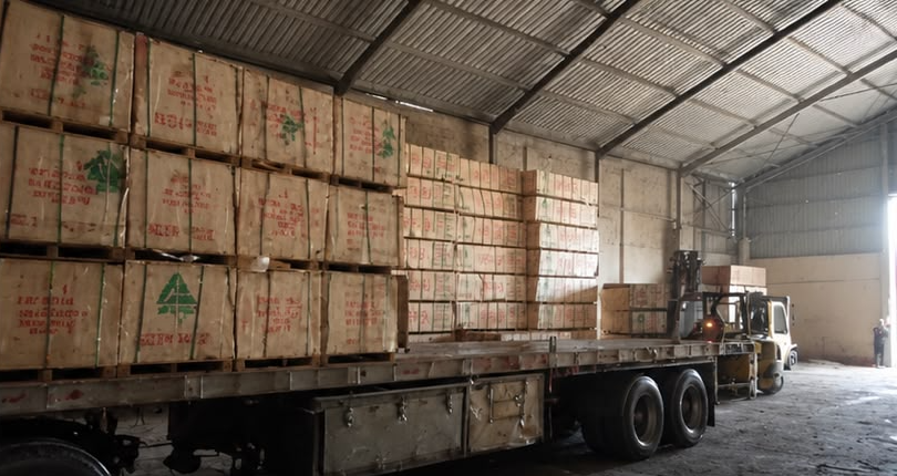 Timber crates stacked in a covered warehouse